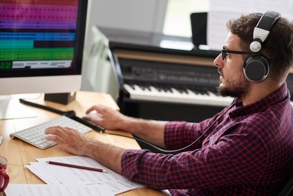 Composer listening to new song